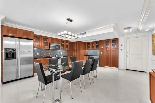 a view of a dining room with furniture and chandelier