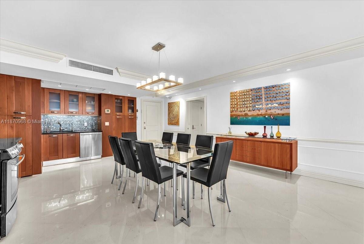 9801 Collins Avenue, Unit 4Y Bal Harbour, FL 33154 - Photo 15 of 71 a view of a dining room with furniture and chandelier