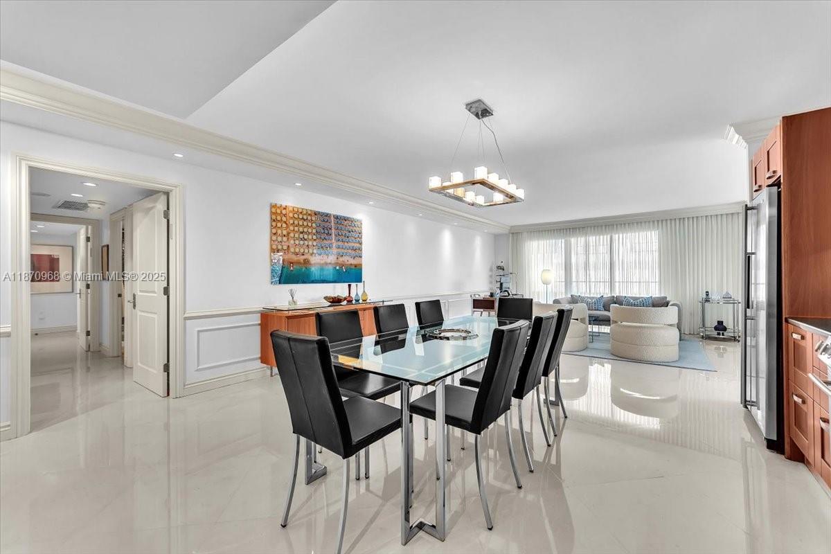 9801 Collins Avenue, Unit 4Y Bal Harbour, FL 33154 - Photo 16 of 71 a view of a dining room with furniture and chandelier