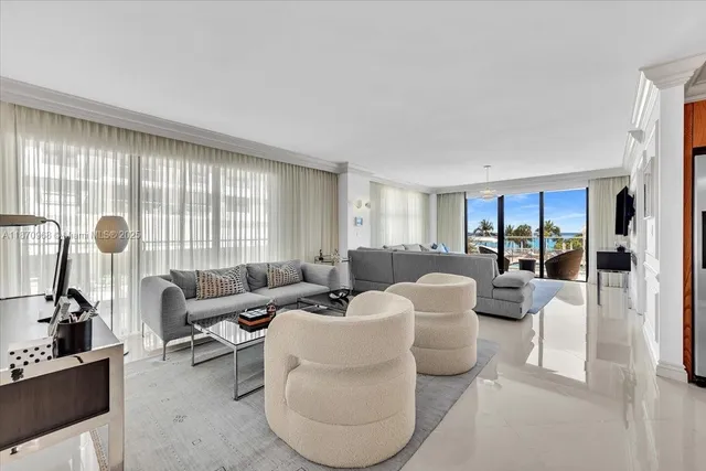 a living room with furniture a flat screen tv and a large window