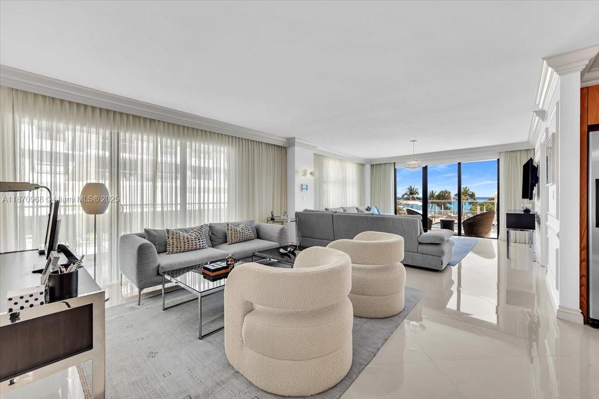 9801 Collins Avenue, Unit 4Y Bal Harbour, FL 33154 - Photo 20 of 71 a living room with furniture and a floor to ceiling window