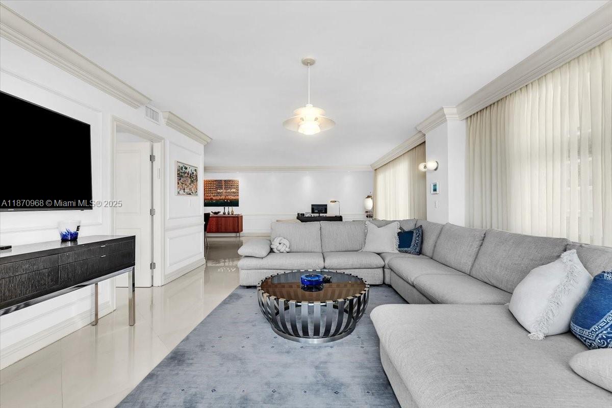 9801 Collins Avenue, Unit 4Y Bal Harbour, FL 33154 - Photo 29 of 71 a living room with furniture and a flat screen tv