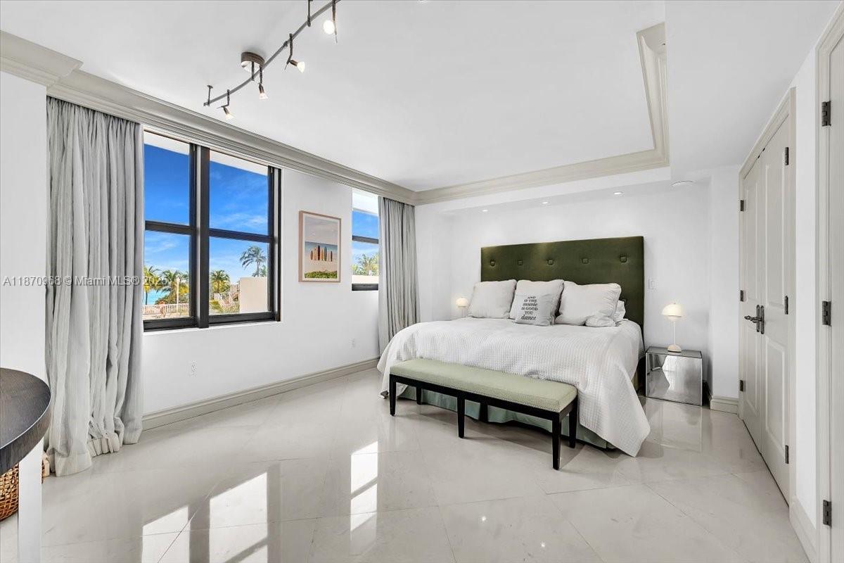 9801 Collins Avenue, Unit 4Y Bal Harbour, FL 33154 - Photo 31 of 71 a bedroom with a bed and window