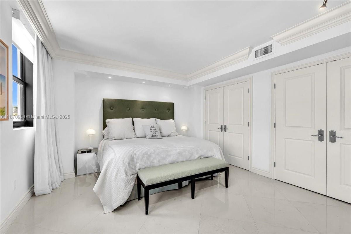 9801 Collins Avenue, Unit 4Y Bal Harbour, FL 33154 - Photo 32 of 71 a bed room with a bed and a night stand