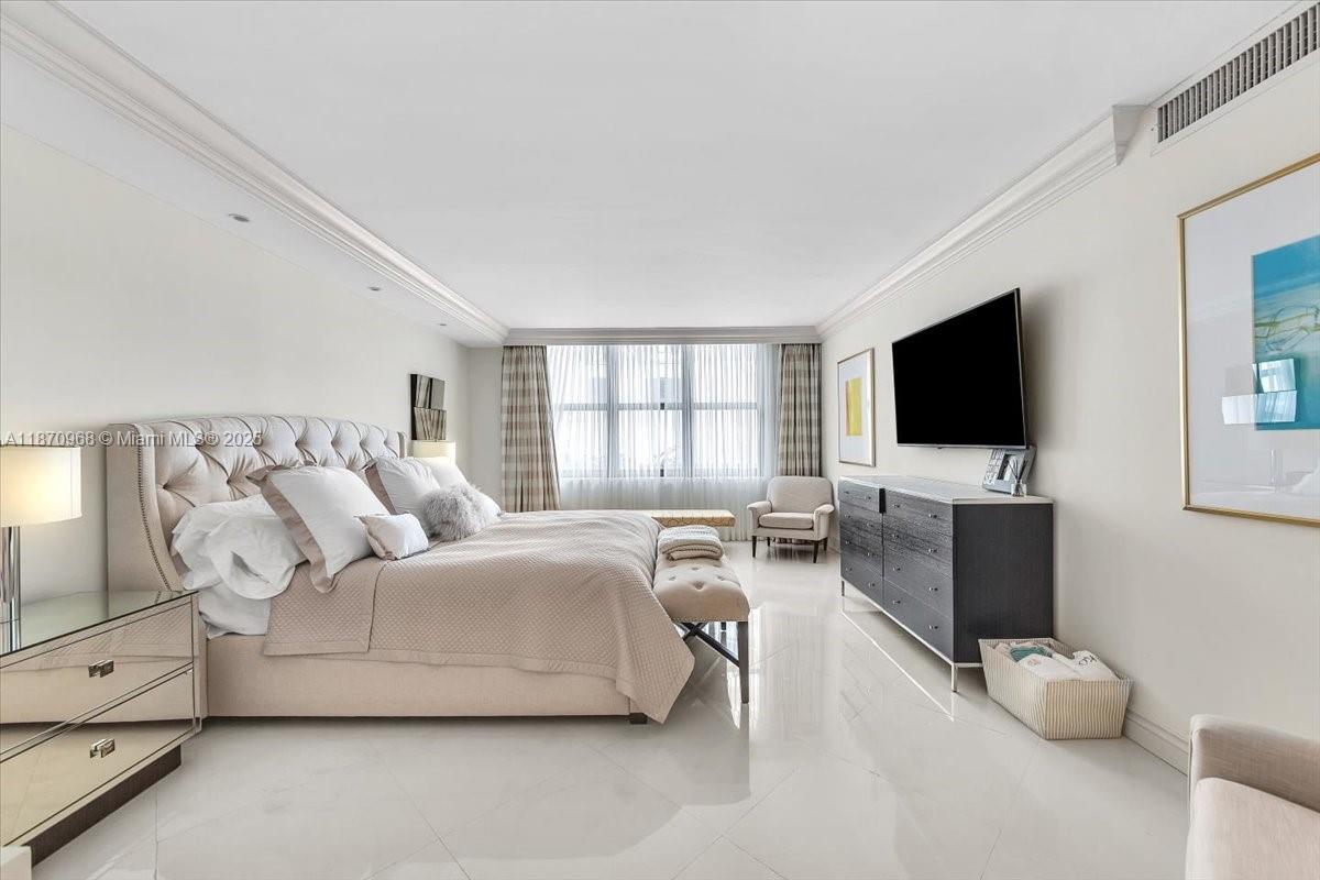 9801 Collins Avenue, Unit 4Y Bal Harbour, FL 33154 - Photo 46 of 71 a living room with furniture and a flat screen tv