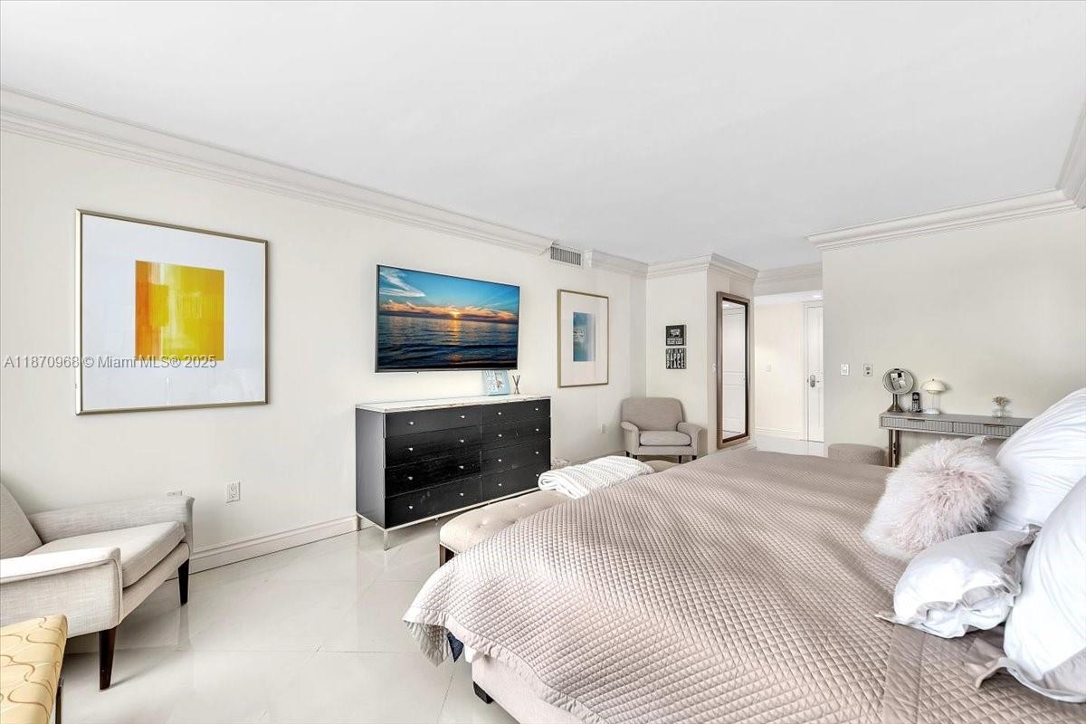 9801 Collins Avenue, Unit 4Y Bal Harbour, FL 33154 - Photo 47 of 71 a bedroom with a bed and a flat screen tv