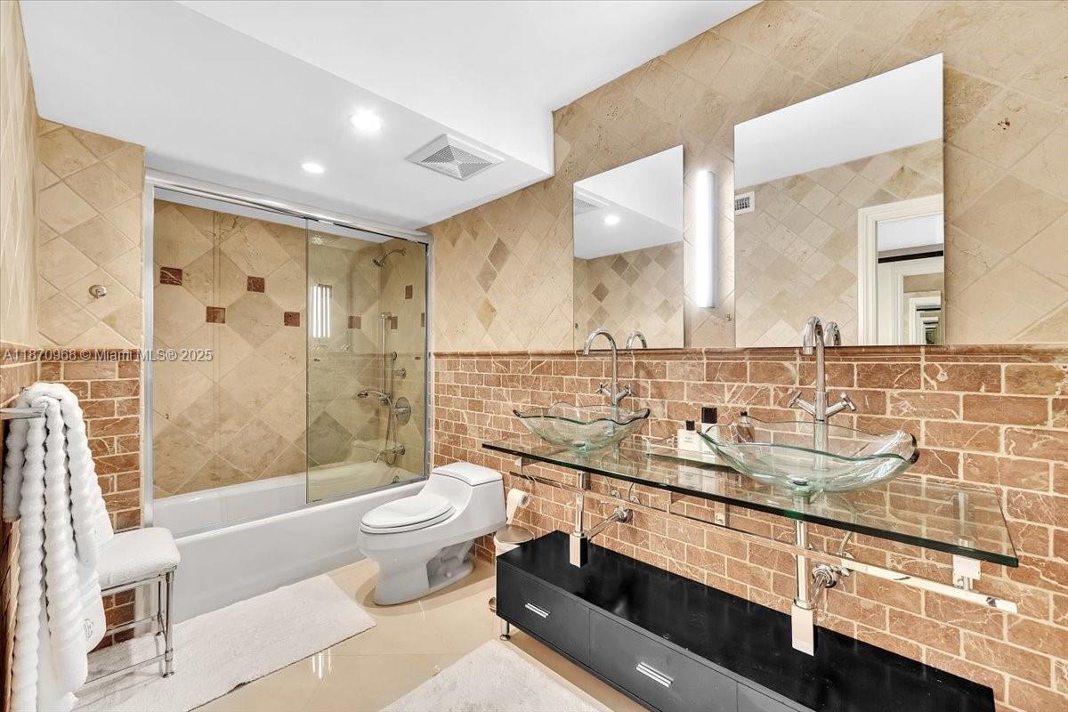 9801 Collins Avenue, Unit 4Y Bal Harbour, FL 33154 - Photo 50 of 71 a bathroom with a sink a toilet and shower