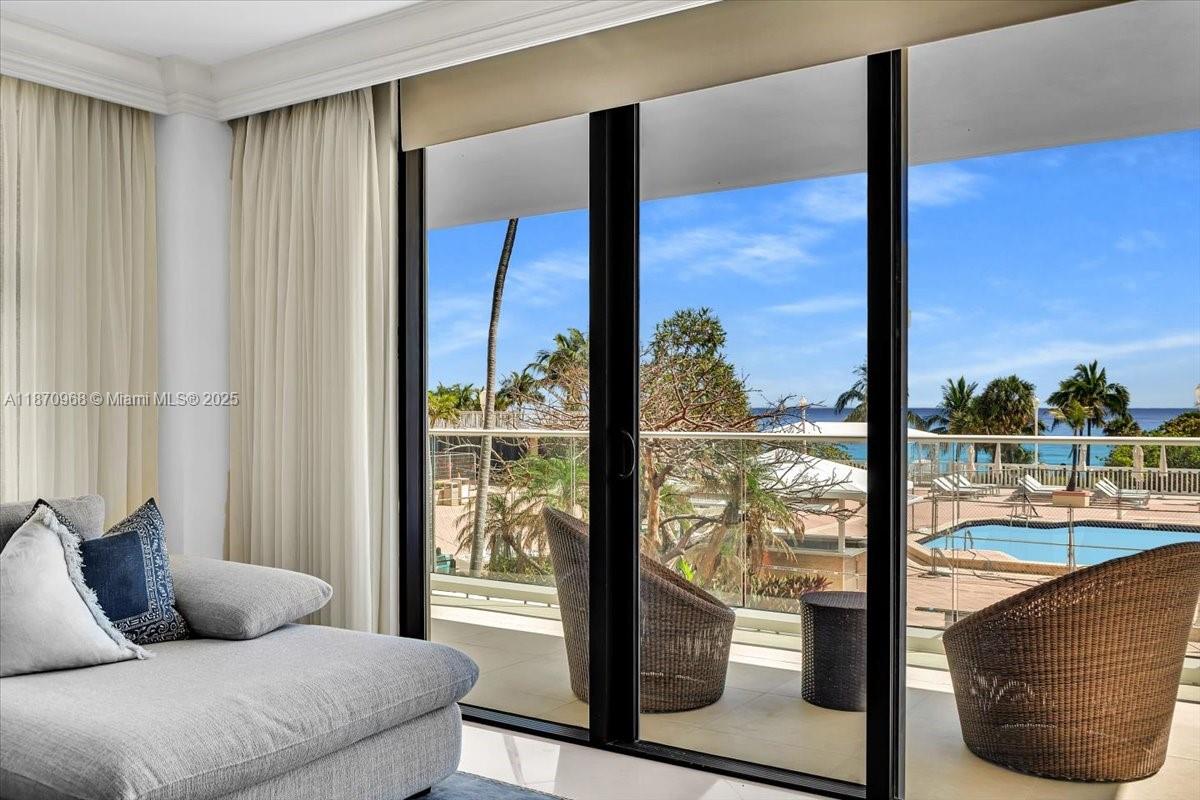 9801 Collins Avenue, Unit 4Y Bal Harbour, FL 33154 - Photo 5 of 71 a living room with furniture and a floor to ceiling window