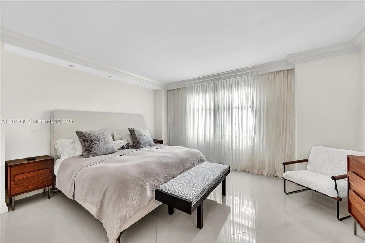 9801 Collins Avenue, Unit 4Y Bal Harbour, FL 33154 - Photo 53 of 71 a bedroom with a bed chair and window