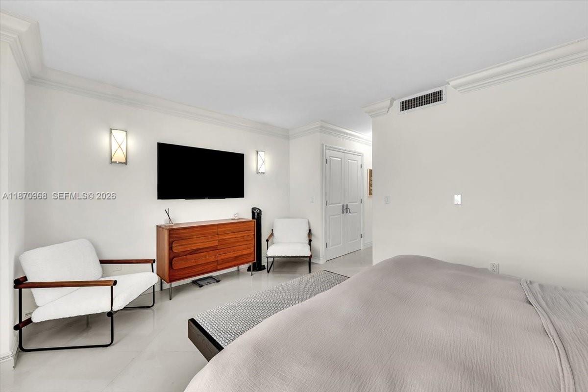 9801 Collins Avenue, Unit 4Y Bal Harbour, FL 33154 - Photo 54 of 72 a bedroom with furniture and a flat screen tv