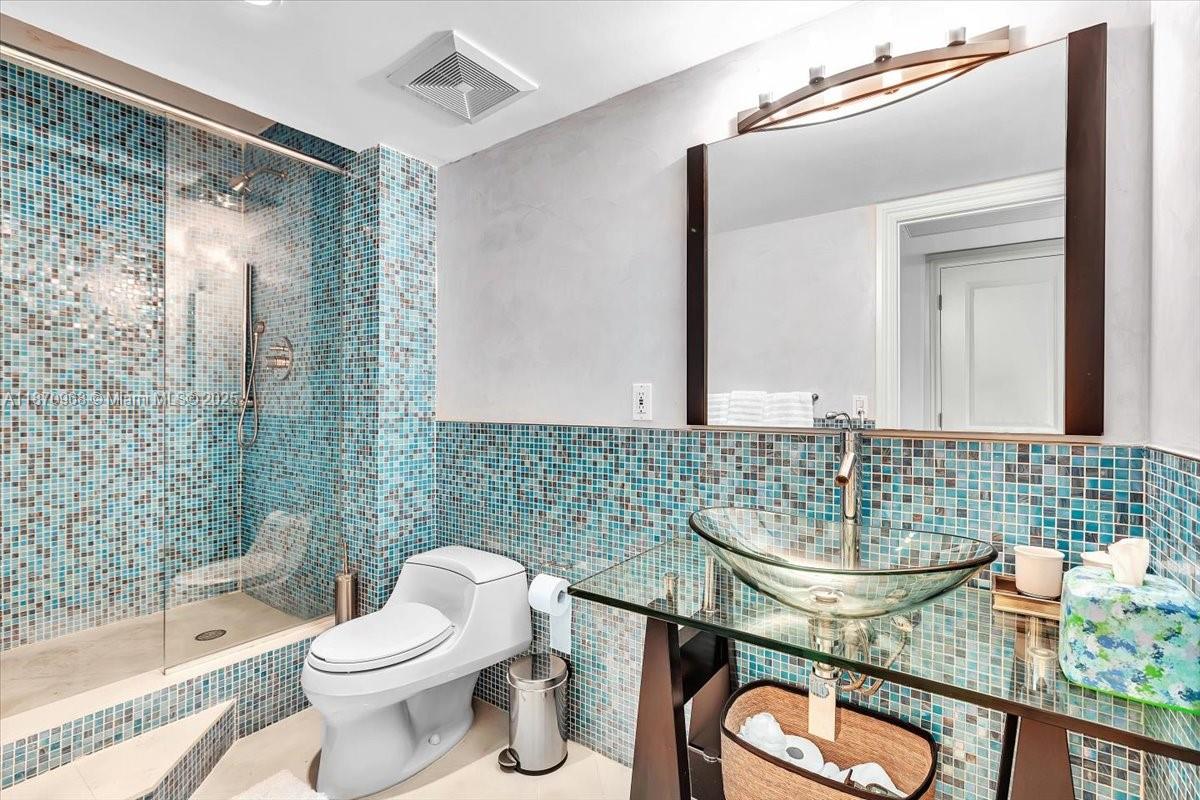 9801 Collins Avenue, Unit 4Y Bal Harbour, FL 33154 - Photo 56 of 71 a bathroom with a sink a toilet and shower