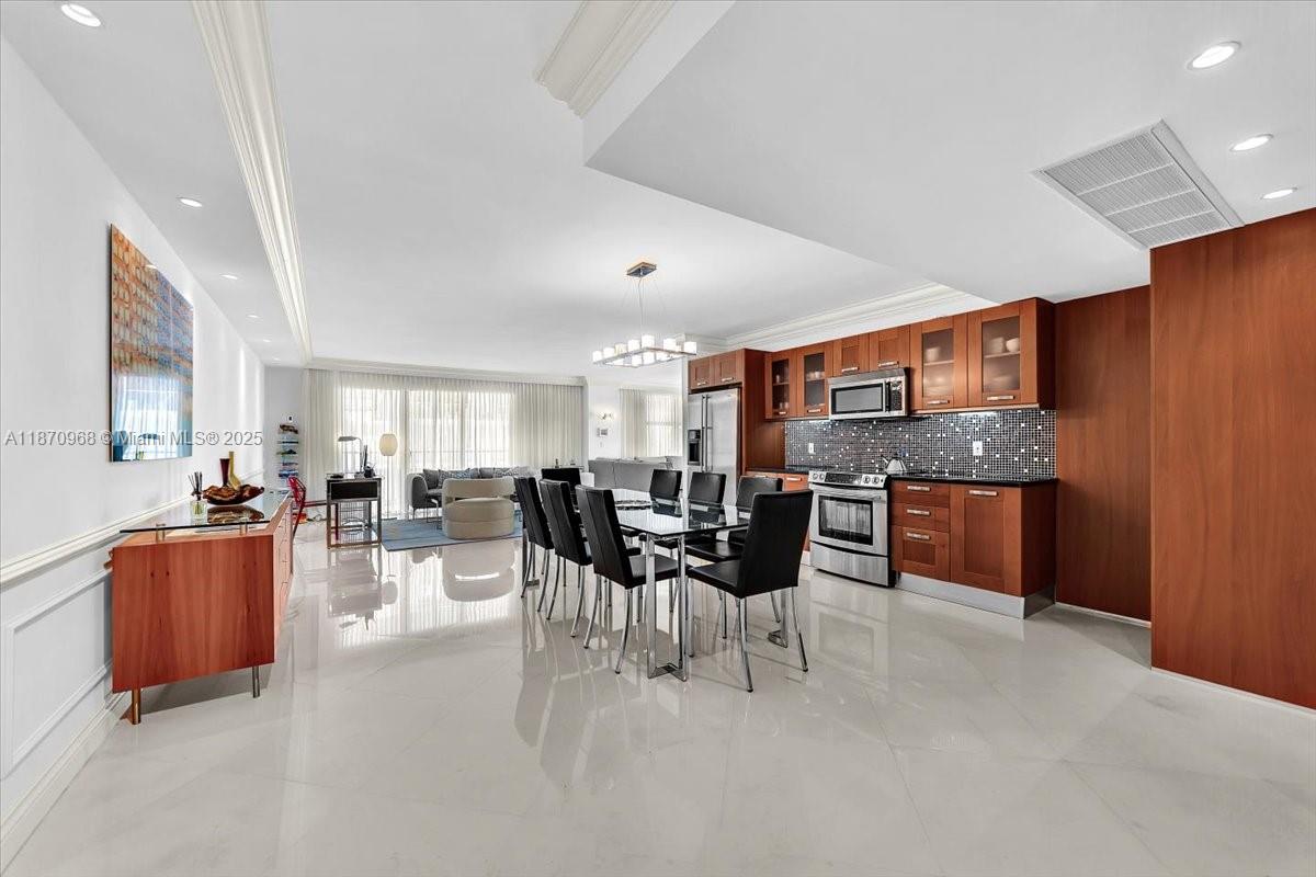 9801 Collins Avenue, Unit 4Y Bal Harbour, FL 33154 - Photo 9 of 71 a living room with furniture a dining table and kitchen view