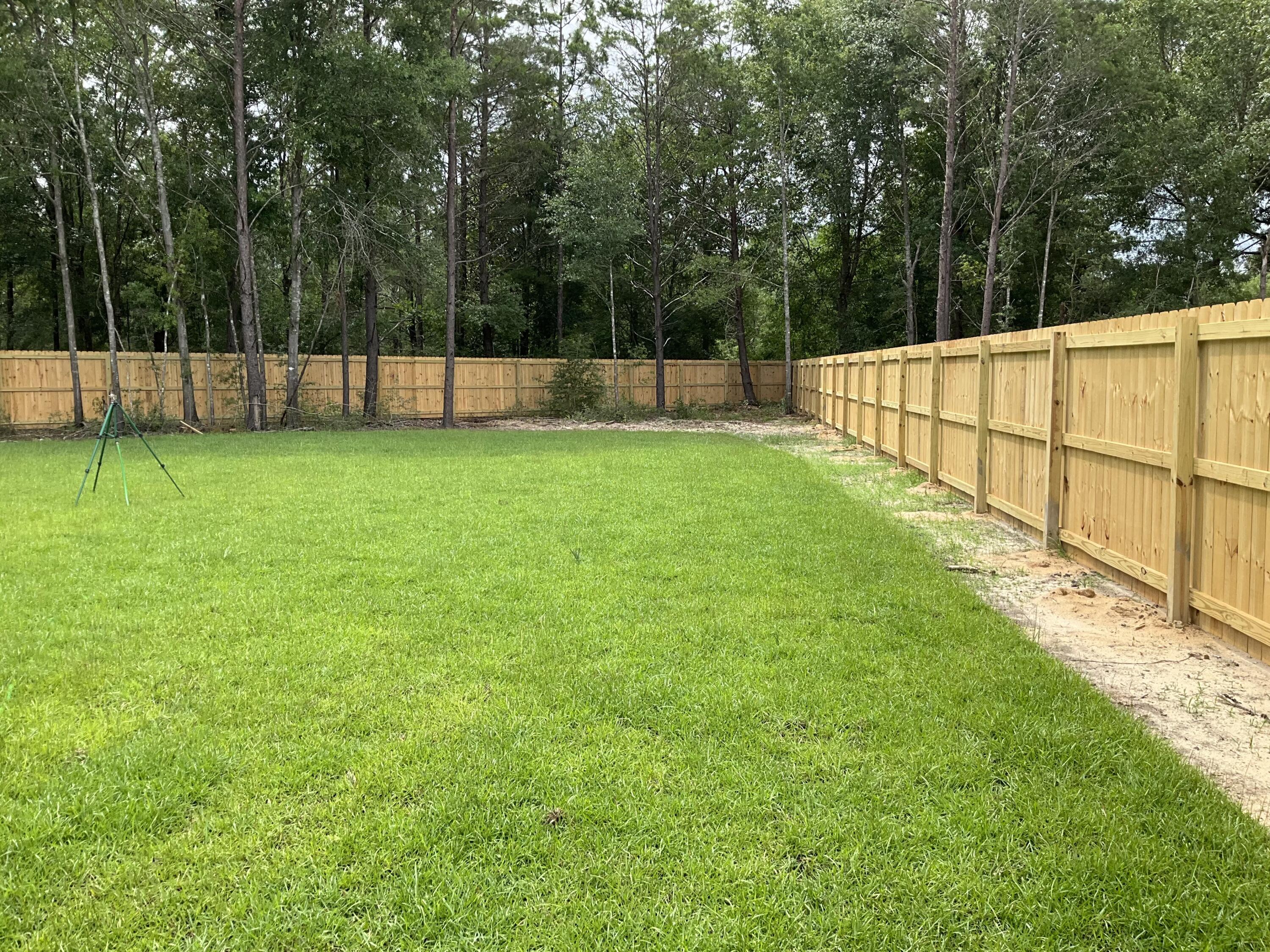 6120 Mildreds Way Crestview, FL 32539 - Photo 3 of 22 a view of yard with green space and wooden fence