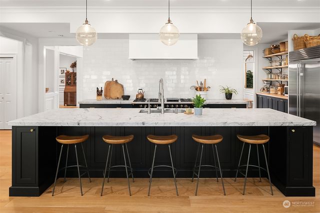 a kitchen with a counter space a sink and cabinets