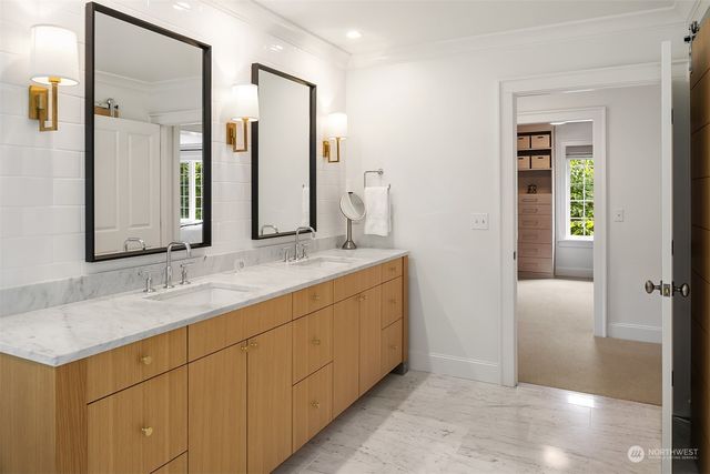 a bathroom with a double vanity sink and a mirror