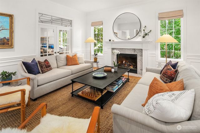 a living room with furniture a fireplace a window and a fireplace