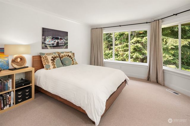 a bed sitting in a bedroom next to a window