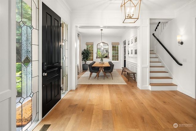 a view of a hallway with wooden floor and staircase