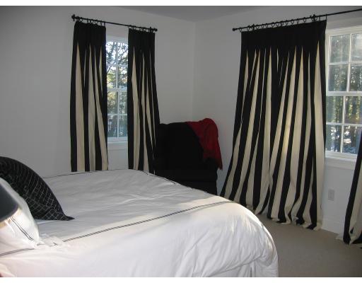 1080 North Street Walpole, MA 02081 - Photo 13 of 20 a bedroom with a bed and a mirror