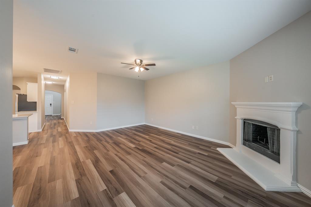 412 Hideaway Road McKinney, TX 75072 - Photo 9 of 40 a view of empty room with wooden floor and fireplace