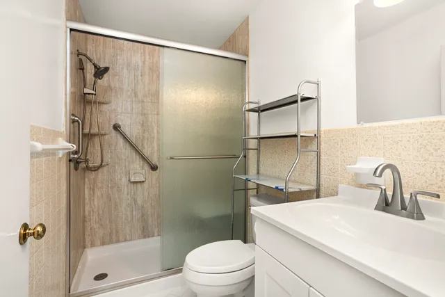 a bathroom with a sink toilet and shower
