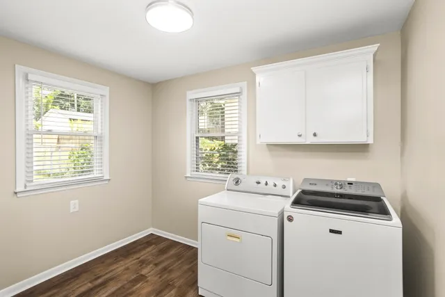 a utility room with closet a window washer and dryer