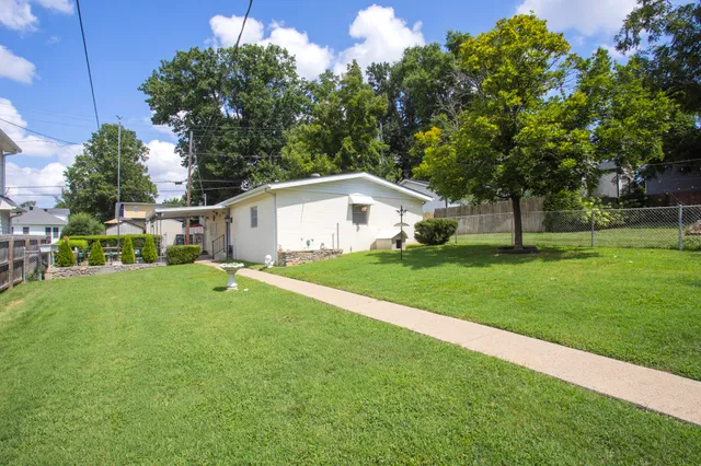 a house view with garden space and trees