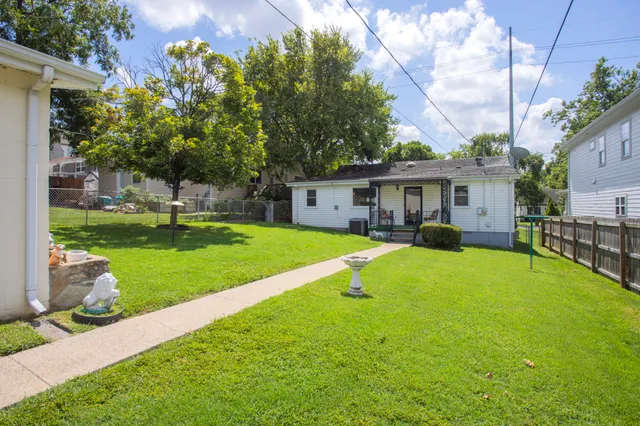 a view of a house with a yard and a patio