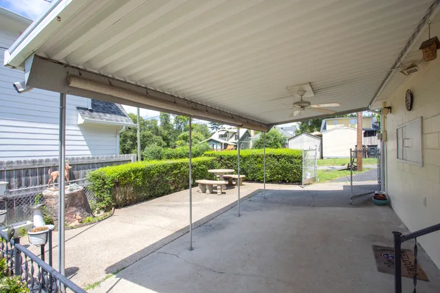 a view of a porch with chairs and backyard