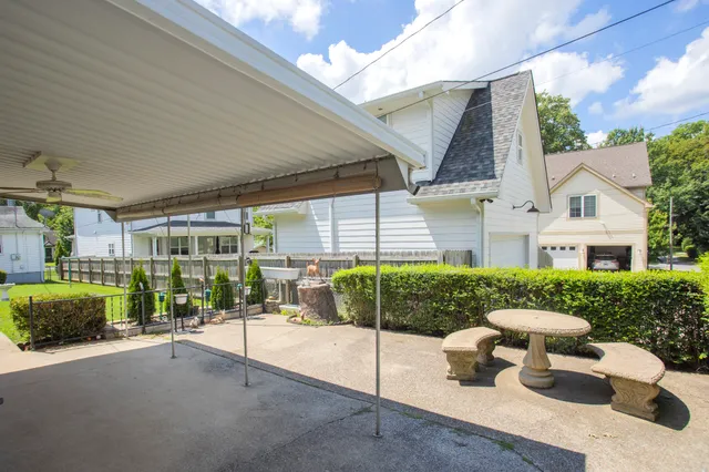 a view of a patio with table and chairs and potted plants