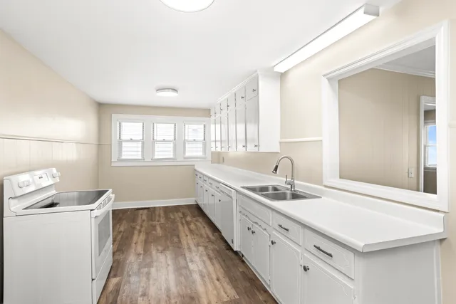 a bathroom with a sink a mirror and a window