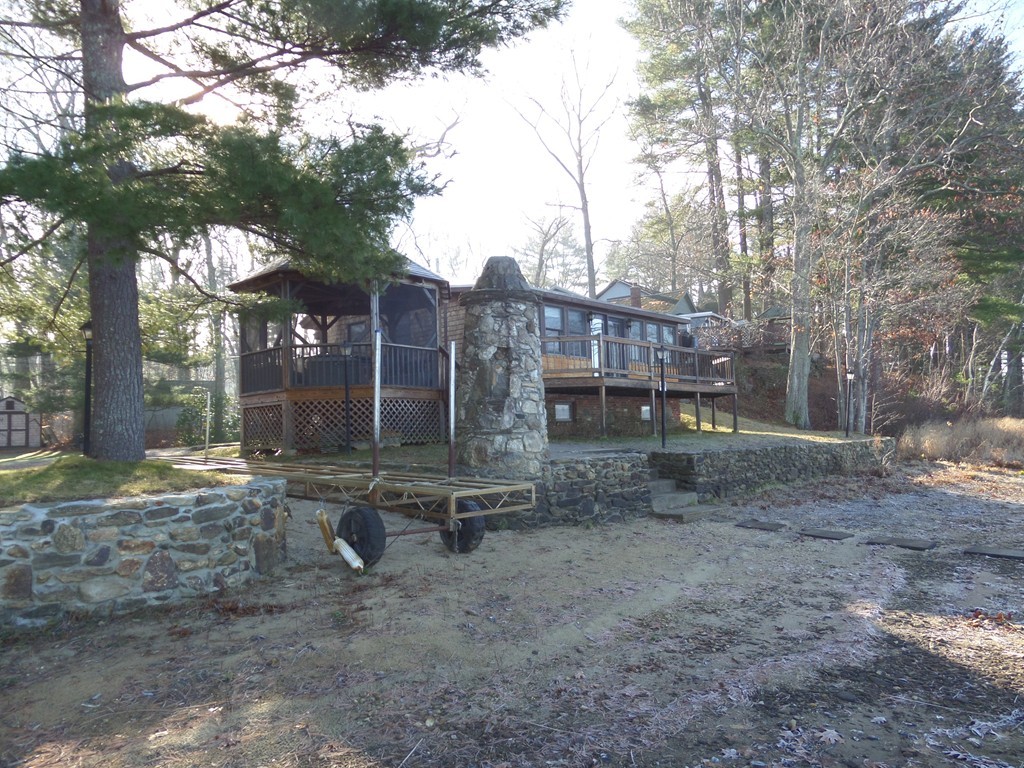 180 Red Gable Road East Brookfield, MA 01515 - Photo 4 of 25 a backyard of a house with barbeque oven table and chairs