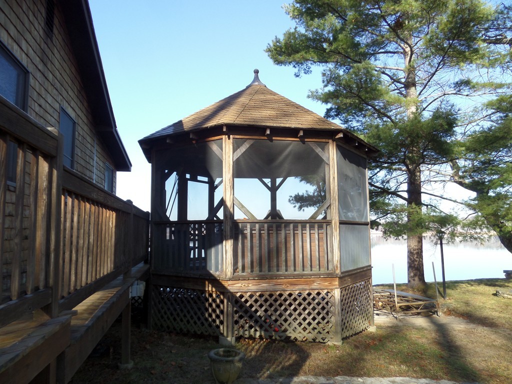 180 Red Gable Road East Brookfield, MA 01515 - Photo 5 of 25 a view of balcony with wooden fence and trees