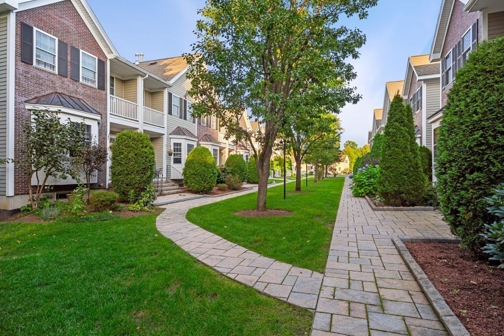 a view of a brick house with a yard