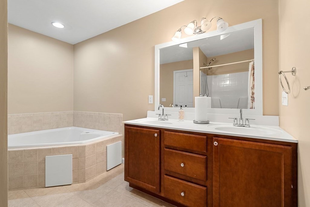 21 Conover Way, Unit 21 Haverhill, MA 01835 - Photo 13 of 31 a bathroom with a tub a sink and mirror