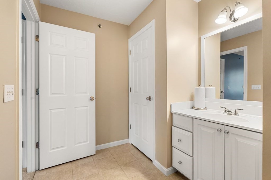 21 Conover Way, Unit 21 Haverhill, MA 01835 - Photo 24 of 31 a bathroom with a sink a mirror and a vanity