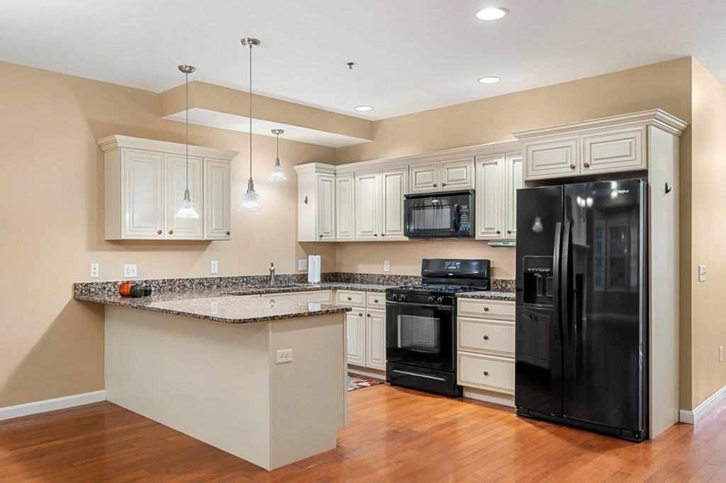 21 Conover Way, Unit 21 Haverhill, MA 01835 - Photo 4 of 31 a kitchen with stainless steel appliances granite countertop a stove a sink and a refrigerator