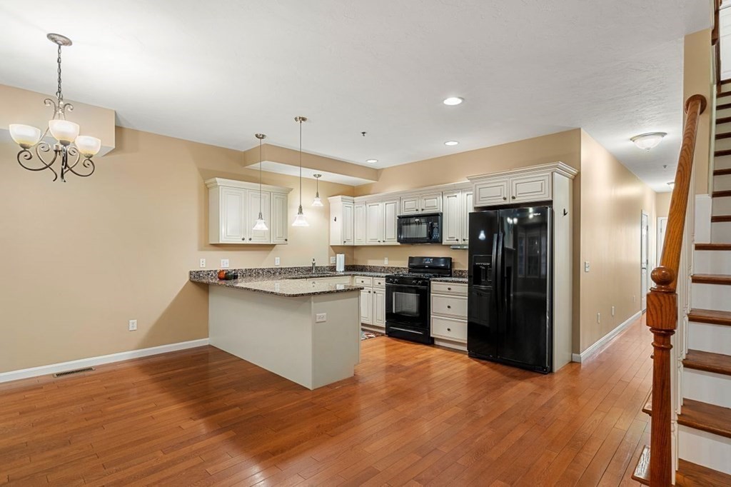 21 Conover Way, Unit 21 Haverhill, MA 01835 - Photo 5 of 31 a kitchen with stainless steel appliances granite countertop a refrigerator and a stove top oven