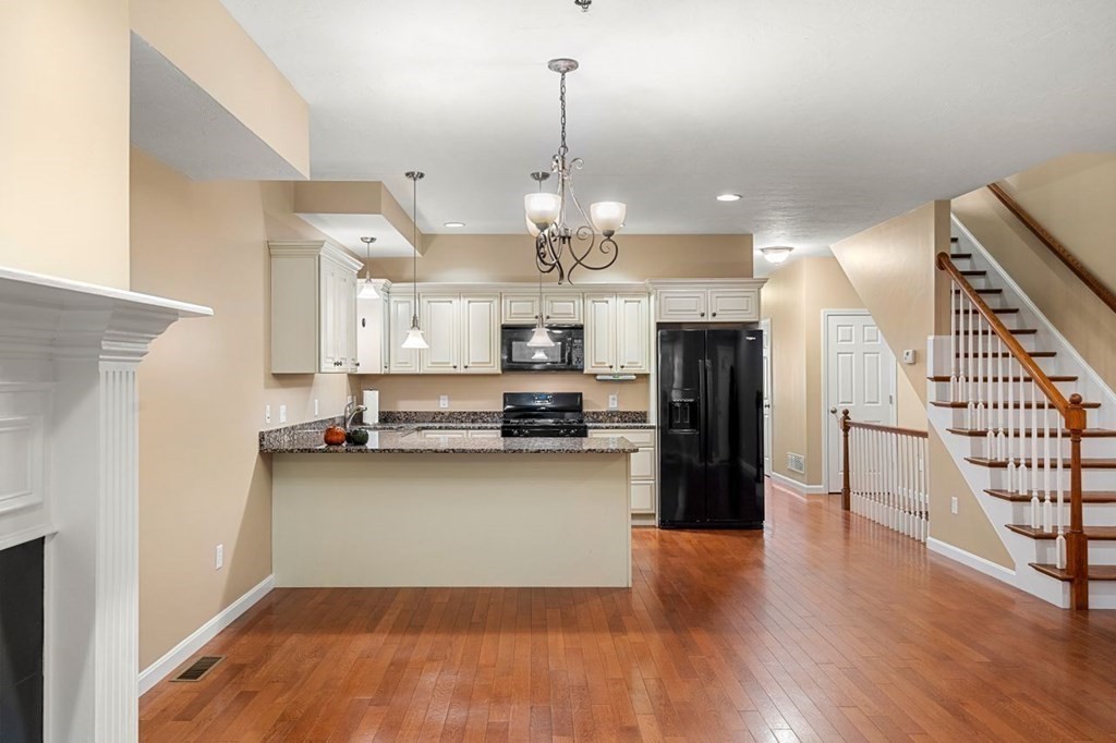 21 Conover Way, Unit 21 Haverhill, MA 01835 - Photo 7 of 31 a view of a kitchen and dining room with wooden floor