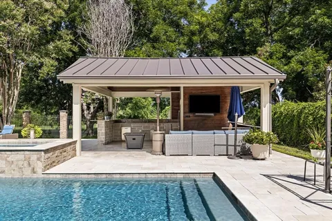 a view of a house with backyard sitting area and garden