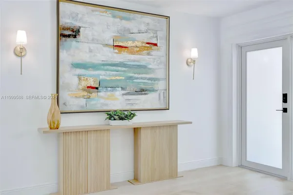 a living room with furniture and a view of kitchen