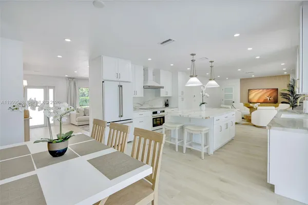 a large kitchen with granite countertop a stove oven and a refrigerator
