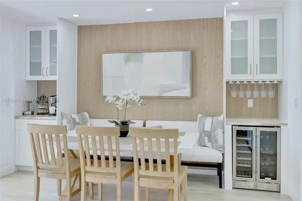 a view of a dining room with furniture a chandelier and wooden floor