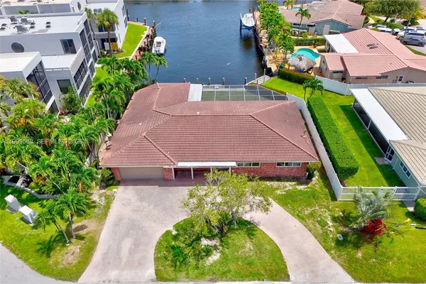an aerial view of a house with a garden and swimming pool