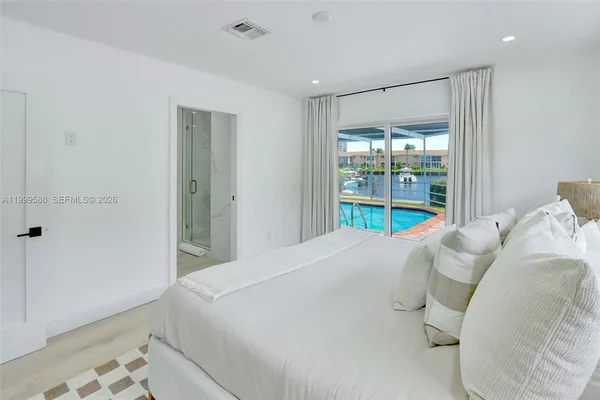 a view of a bedroom with a bed and balcony