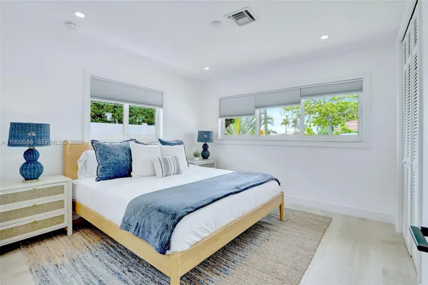 a bedroom with furniture and a window
