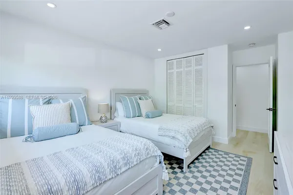 a bathroom with double vanity sink and a mirror