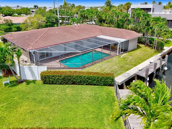 an aerial view of a house with swimming pool garden and patio