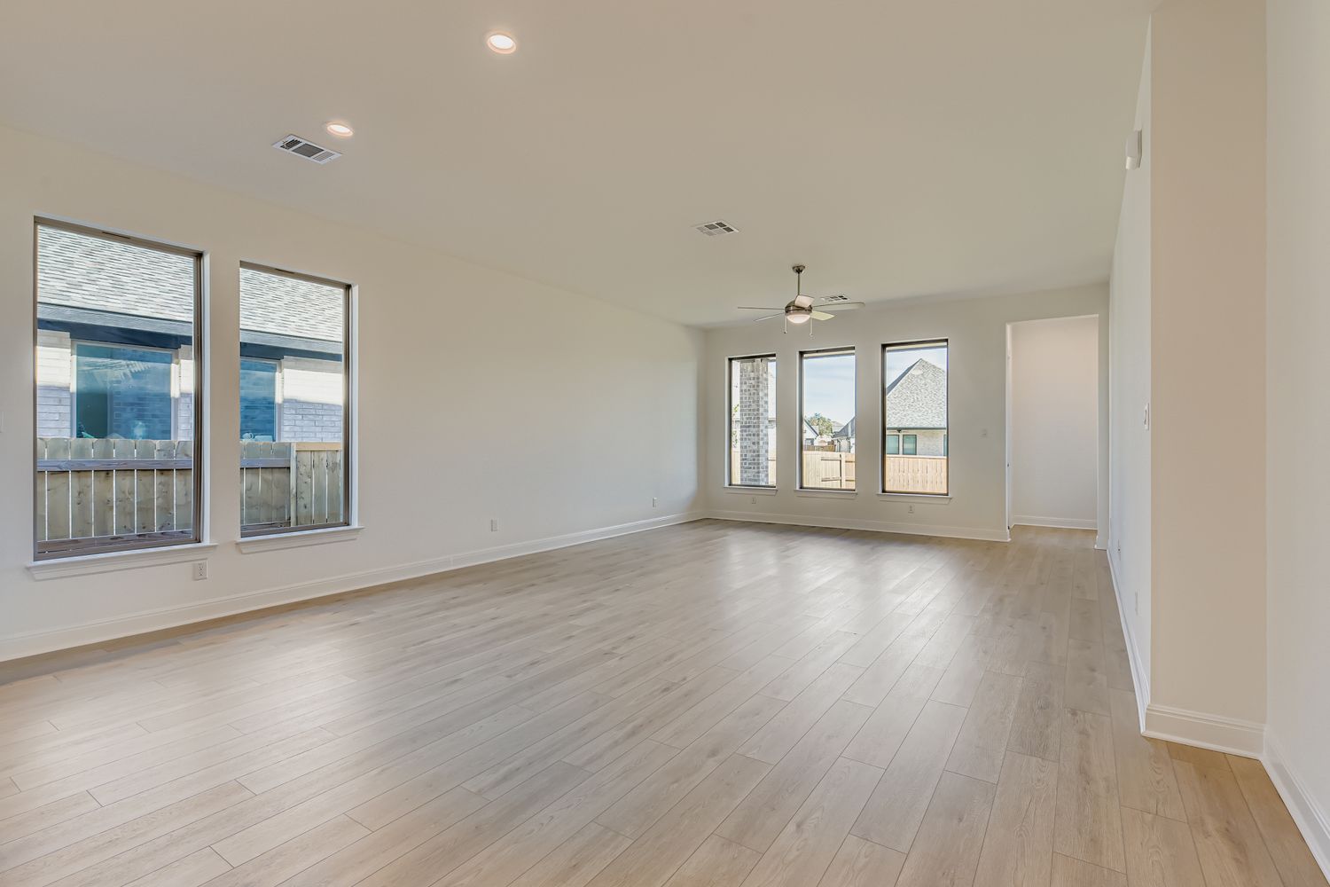 395 Prickly Poppy Loop Kyle, TX 78640 - Photo 2 of 11 wooden floor in an empty room with a window