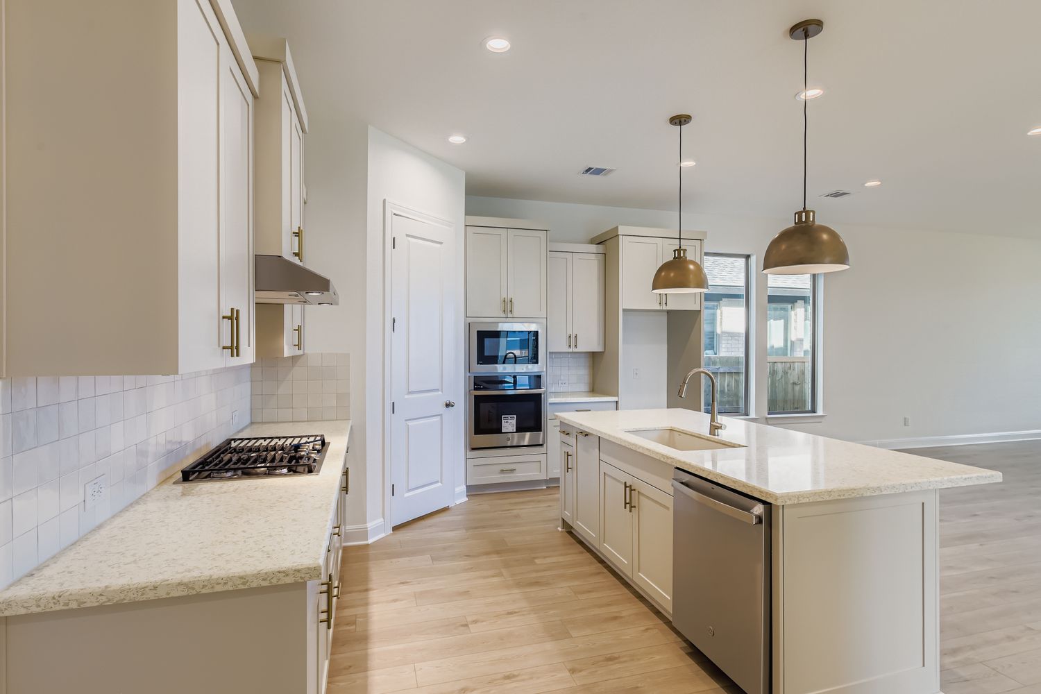 395 Prickly Poppy Loop Kyle, TX 78640 - Photo 3 of 11 a large kitchen with stainless steel appliances granite countertop a stove and a refrigerator